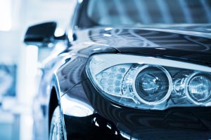 Hamburg, Germany - May 2, 2010 : Close up from the left front of a parking blue BMW 530d. Shallow depth of field with fokus on the headlight. BMW is a German automobile, motorcycle and engine manufacturing company founded in 1916